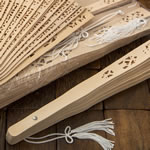 Intricately carved Sandalwood fan favors from Fashioncraft&reg;