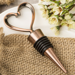 Heart shaped metal bottle stopper in a Copper plated finish  in a burlap bag